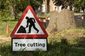 Occupation: Closeup of a hazard sign in front of a tree stump. 2