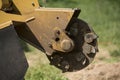 Occupation: Closeup of a stump grinder ready to remove a tree stump.