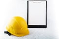 Occupational safety in construction, health protection, hard hat with sheet for text in clipboard