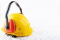 Occupational Safety and Health, ear protectors construction hard hat on background of architectural drawings with copy space, Royalty Free Stock Photo