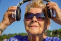 Occupational therapy. Elderly and technology. Lady listen to music with headphones