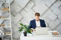 Busy male sitting at desktop with tablet Royalty Free Stock Photo