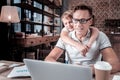 Occupied concentrated man sitting and using the laptop. Royalty Free Stock Photo