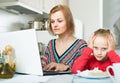 woman working from home, little daughter asking for attention Royalty Free Stock Photo