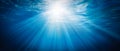 Ocean background - Sun shining light sunlight sunshine in blue clearly deep water, sunbeams illuminate the blue underwater sea, AI Royalty Free Stock Photo