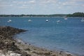 Ocean bay with breakwater, sharp spit of land, boats