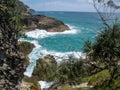 Ocean bay with rocks, cliffs and tropical plants on a clear day in summer Royalty Free Stock Photo