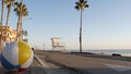 Ocean beach California USA. Ball, lifeguard tower, life guard watchtower hut, beachfront palm tree.