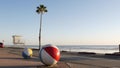 Ocean beach California USA. Ball, lifeguard tower, life guard watchtower hut, beachfront palm tree.