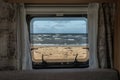 Ocean beach Sea view from the window of a camping caravan camper trailer. Road trip on the coast of sweden Royalty Free Stock Photo