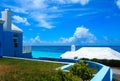 Ocean Blue Waters with black Rocky Beach Blue Sky white clouds in the horizon Royalty Free Stock Photo