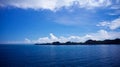 The ocean with bright blue skies and white clouds. Royalty Free Stock Photo