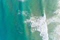 The ocean is calm and blue with white foam on the waves, aerial drone view Royalty Free Stock Photo