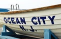 Ocean City New Jersey Sign on a White Boat placed on the BeachOcean City New Jersey Sign on a White Boat placed on the Beach