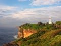 Ocean Cliffs With a White Lighthouse Royalty Free Stock Photo