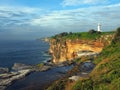 Ocean Cliffs With a White Lighthouse Royalty Free Stock Photo