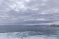 Ocean coast time-lapse during afternoon day with fast moving bright clouds moving sea and taking off planes from Gran Canary Royalty Free Stock Photo