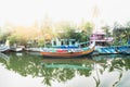 Ocean fishing boat with lens flare along the canal Kerala backwaters shore with palm trees between Alappuzha and Kollam, India Royalty Free Stock Photo