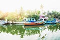 Ocean fishing boats with lens flare along the canal Kerala backwaters shore with palm trees between Alappuzha and Kollam, India Royalty Free Stock Photo