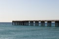 Ocean fishing pier stretchs over calm seas Royalty Free Stock Photo