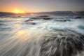 Ocean flowing over rocks Bungan Beach