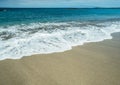 Ocean foam covering beautiful long sandy beach Royalty Free Stock Photo