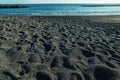 Ocean foam covering wonderful black sand beach of Tenerife island