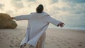 Ocean girl open arms feel free at empty beach. Black hair woman breathing rest Royalty Free Stock Photo