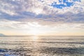 Ocean horizont with cloudy sky and burning sun Royalty Free Stock Photo