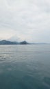 the ocean and an island that looks very calm