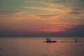 Ocean landscape at sunset. Silhouettes of fishermen. Royalty Free Stock Photo