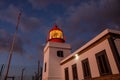 Ocean lighthouse during the sunset. Dramatic clouds on the background. Royalty Free Stock Photo