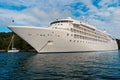 Ocean liner in sea in Fowey, United Kingdom. Cruise ship at seacoast on cloudy sky. Summer vacation on tropical island Royalty Free Stock Photo