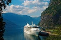 Ocean liner in sea port on mountain landscape in Flam, Norway. Cruise ship in sea harbor with green mountains. Cruise