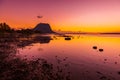 Ocean at low tide and colorful sunset time. Le Morn mountain in Mauritius Royalty Free Stock Photo