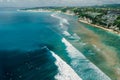 Ocean with perfect waves and coastline with hotels on Impossibles beach in Bali. Aerial view of tropical island Royalty Free Stock Photo