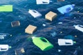 Ocean polluted by plastic and paper material, bottles and boxes Royalty Free Stock Photo