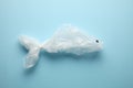 Ocean pollution by household garbage. The problem of disposable plastic bags. A bag in the shape of a fish Royalty Free Stock Photo