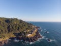 Ocean and rocky coast, where green trees grow. The ocean water is deep blue. Clear blue sky. Calm. There are no clouds. Clear day Royalty Free Stock Photo