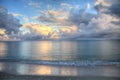 Ocean rolls in under puffy clouds on North Naples Beach at sunrise Royalty Free Stock Photo