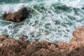 The ocean is rough and the waves are crashing against the rocks. The water is a deep blue color and the rocks are grey. Royalty Free Stock Photo