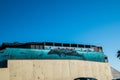 Ocean scene painted on the side of a building showing a large whale and dolphins under water in the ocean