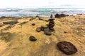 Ocean sea water rushing in to sandy beach shore on a cloudy blue sky. Royalty Free Stock Photo