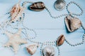 Ocean shells, starfish and pearls on a blue background c Royalty Free Stock Photo