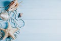 Ocean shells, starfish and pearls on a blue background c Royalty Free Stock Photo