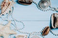 Ocean shells, starfish and pearls on a blue background c Royalty Free Stock Photo
