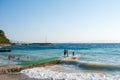 An ocean shorebreak in front view. Big beautiful green blue wave splashing with backwave and ready to break out. White foam Royalty Free Stock Photo