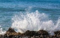 Ocean spray hitting the wet lava rocks on the Peloponnese peninsula of Southern Greece