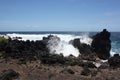 Ocean spray from large waves crashing into lava rock on the shore of Laupahoehoe Point on the Hamakua Coast