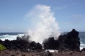 Ocean spray from large waves crashing into lava rock on the shore of Laupahoehoe Point on the Hamakua Coast